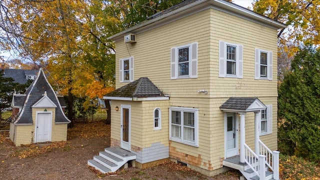 view of front of property with a wall mounted air conditioner