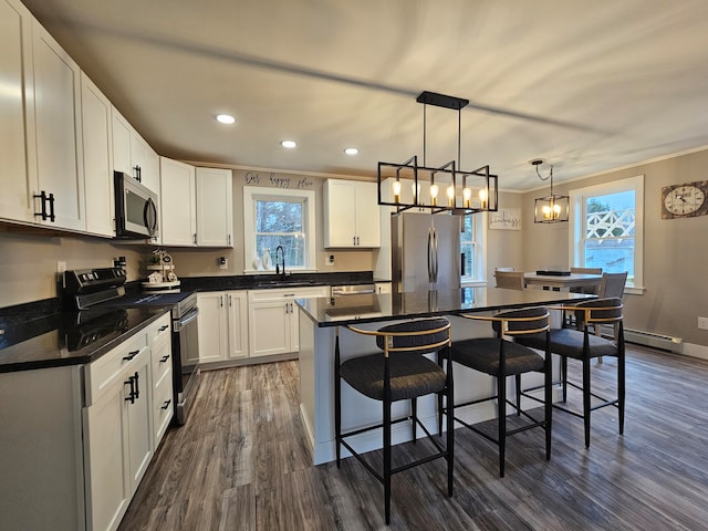 kitchen featuring white cabinets, a kitchen island, and appliances with stainless steel finishes