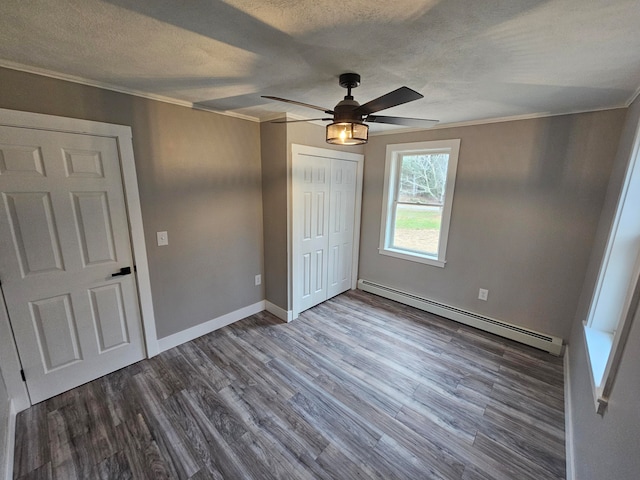 unfurnished bedroom with dark hardwood / wood-style flooring, a baseboard radiator, ceiling fan, and ornamental molding