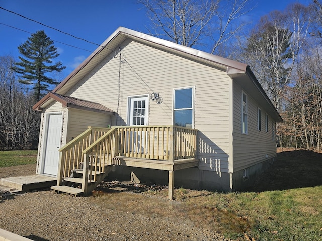 back of property featuring a deck