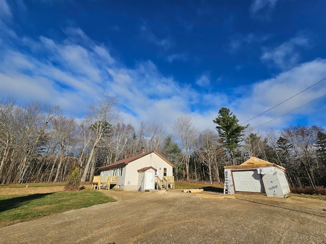 view of side of home featuring a garage and an outdoor structure