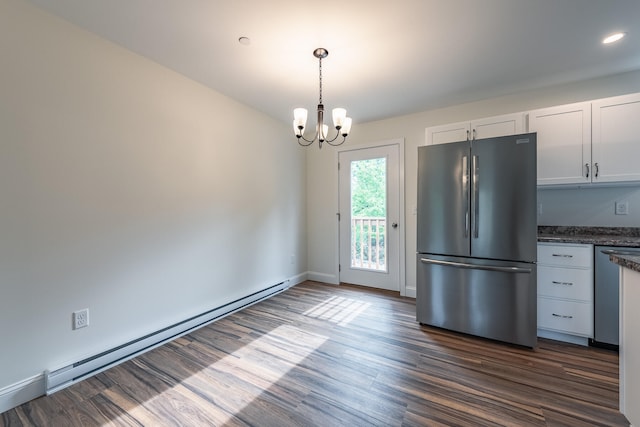 kitchen with dark wood-type flooring, an inviting chandelier, baseboard heating, stainless steel fridge, and white cabinets