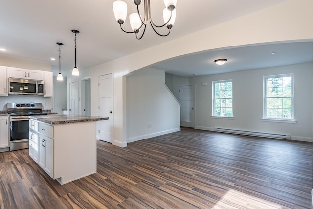 kitchen with white cabinets, baseboard heating, appliances with stainless steel finishes, and dark wood-type flooring