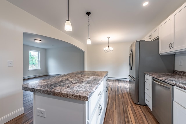 kitchen with white cabinets, dark hardwood / wood-style floors, stainless steel dishwasher, and a kitchen island