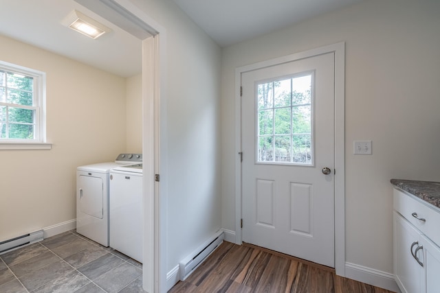 washroom featuring hardwood / wood-style floors, a healthy amount of sunlight, washing machine and dryer, and a baseboard heating unit