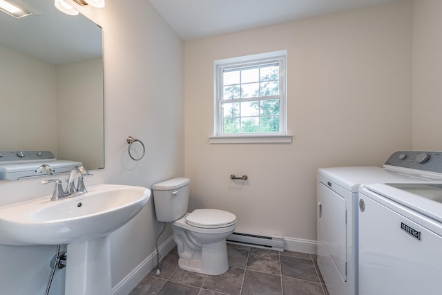 bathroom with washer and clothes dryer, tile patterned floors, sink, toilet, and a baseboard radiator