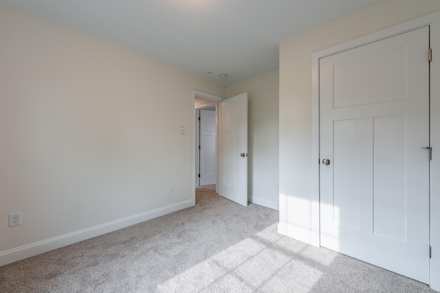 unfurnished bedroom with light colored carpet