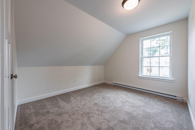 additional living space featuring baseboard heating, carpet, and lofted ceiling