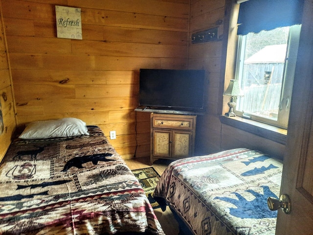 bedroom featuring wood walls and wood-type flooring