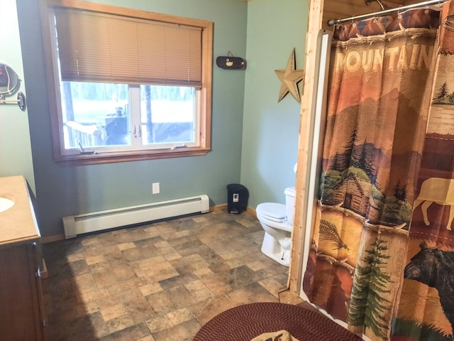 bathroom with vanity, toilet, and a baseboard heating unit