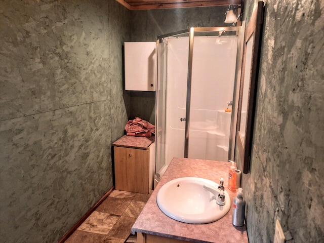 bathroom with walk in shower and vanity