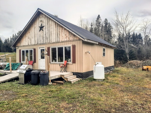 back of house with a lawn