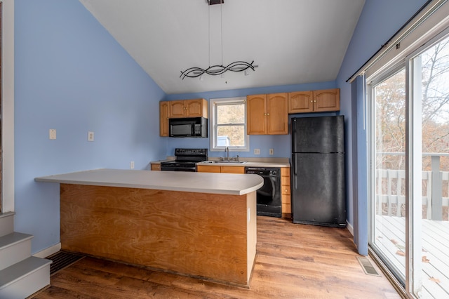 kitchen with light wood-type flooring, black appliances, lofted ceiling, and decorative light fixtures