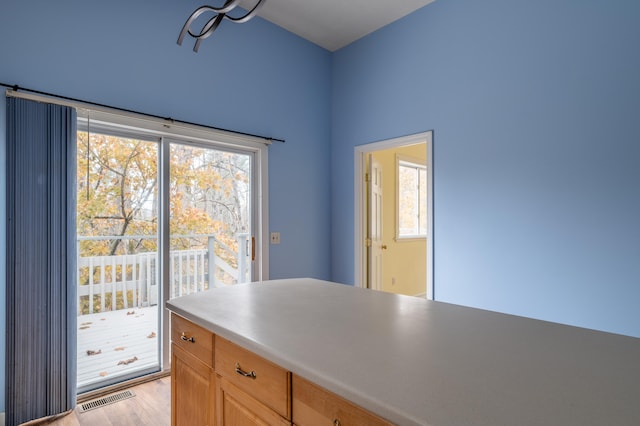 kitchen with light brown cabinetry and light hardwood / wood-style floors