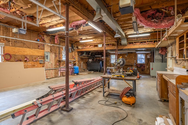 basement with electric panel and a workshop area