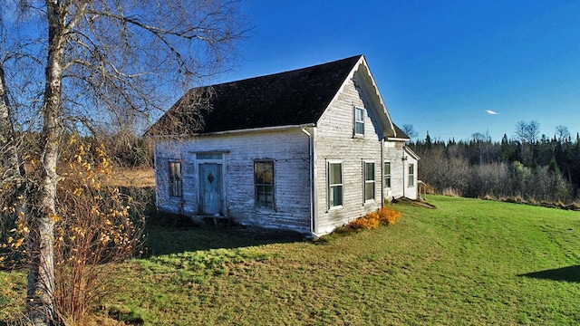 view of property exterior with a lawn