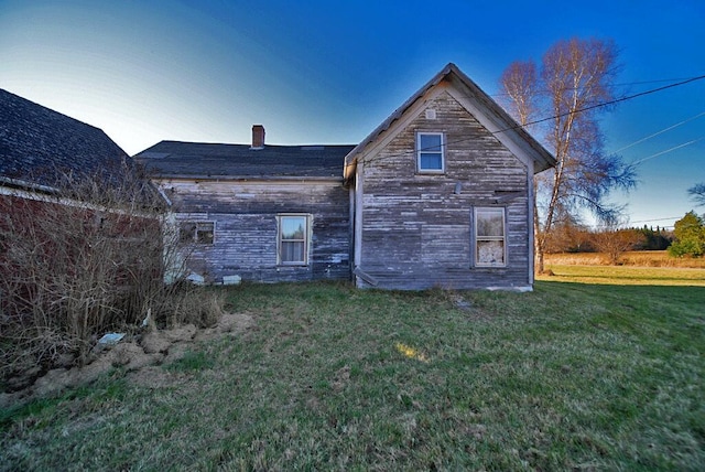 rear view of property with a yard