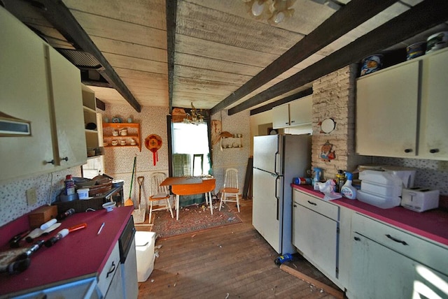 kitchen with dark hardwood / wood-style flooring, beamed ceiling, and white fridge