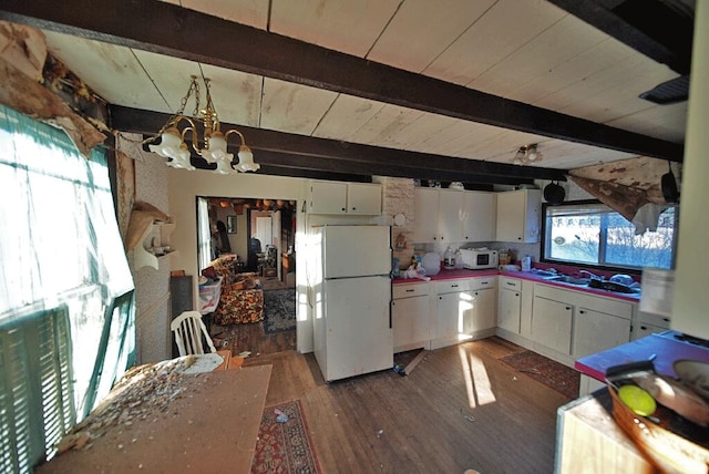 kitchen featuring a notable chandelier, hardwood / wood-style floors, white cabinets, beamed ceiling, and white appliances