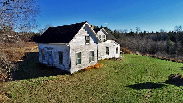 view of property exterior featuring a lawn