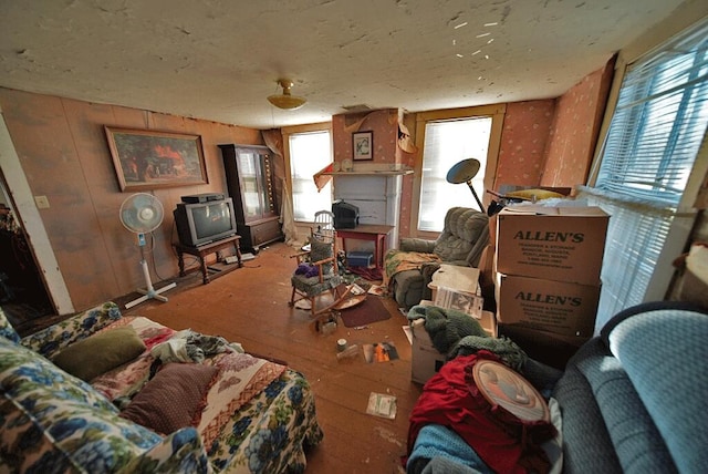 miscellaneous room featuring wood walls, a wealth of natural light, and hardwood / wood-style floors