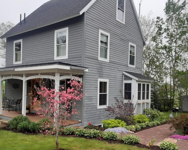 view of side of home featuring a porch