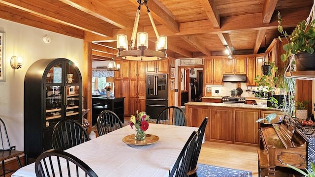 dining space featuring wood ceiling, light hardwood / wood-style floors, and beamed ceiling