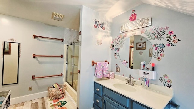 bathroom featuring an enclosed shower, vanity, wood-type flooring, and vaulted ceiling