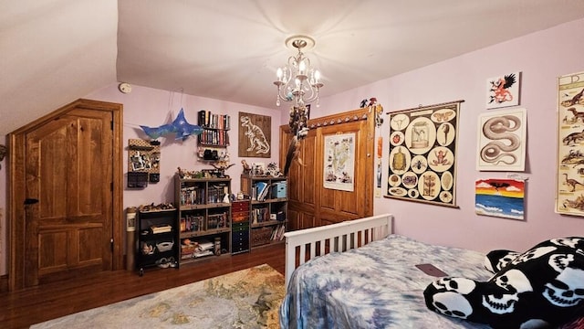 bedroom featuring dark hardwood / wood-style flooring and a chandelier