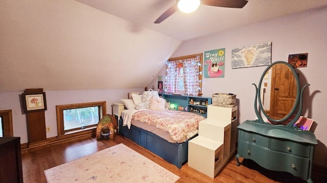 bedroom with lofted ceiling, hardwood / wood-style floors, and ceiling fan