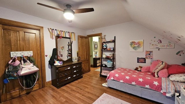 bedroom featuring hardwood / wood-style floors, vaulted ceiling, and ceiling fan