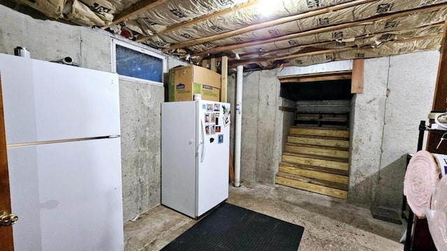 basement with white refrigerator