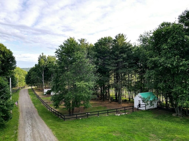 surrounding community featuring a rural view and a lawn