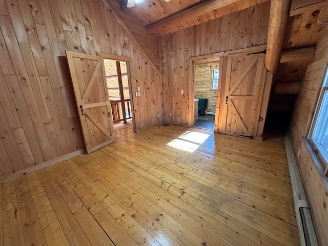 111 Ice Rd, Acton, ME 04001 - spare room with light hardwood / wood-style flooring, a wealth of natural light, and wood walls