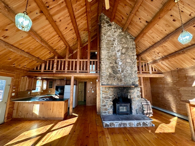 111 Ice Rd, Acton, ME 04001 - kitchen with kitchen peninsula, wood-type flooring, high vaulted ceiling, and wooden walls