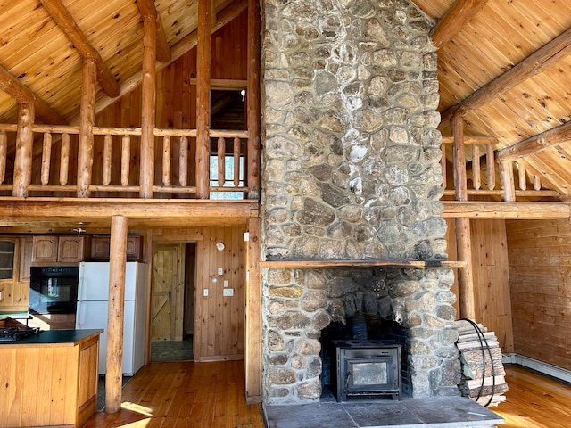 111 Ice Rd, Acton, ME 04001 - unfurnished living room with hardwood / wood-style flooring, a wood stove, and wooden ceiling