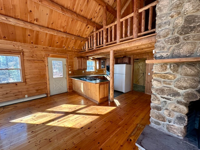 111 Ice Rd, Acton, ME 04001 - kitchen featuring white refrigerator, a baseboard radiator, light hardwood / wood-style flooring, wooden ceiling, and wood walls
