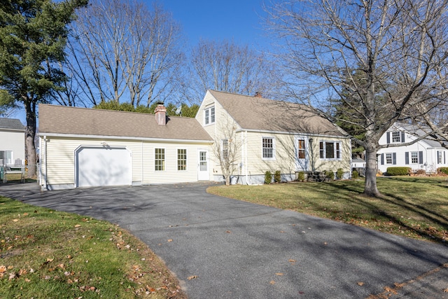 cape cod-style house with a front lawn and a garage