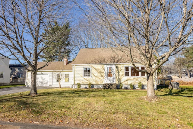 view of front of house with a garage and a front yard