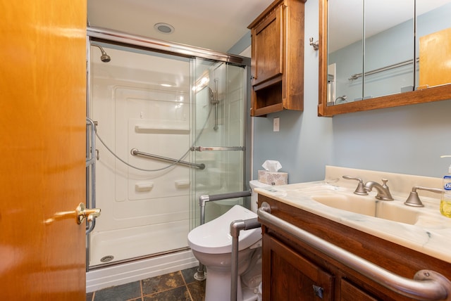 bathroom with tile patterned floors, vanity, toilet, and a shower with door