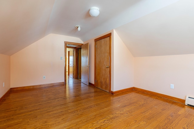 bonus room featuring hardwood / wood-style floors and lofted ceiling