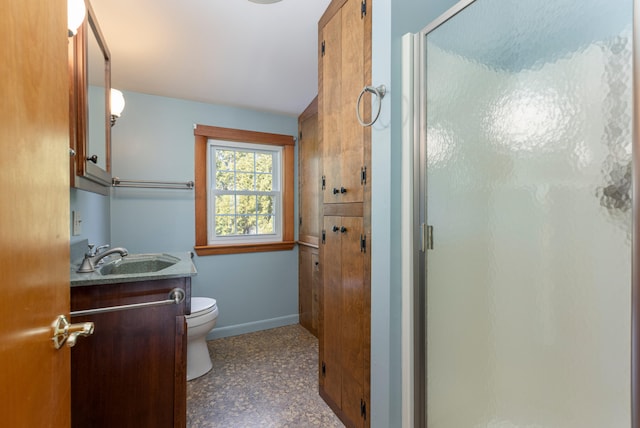 bathroom with vanity, toilet, and walk in shower