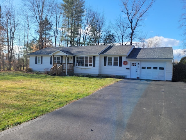 single story home featuring a garage and a front lawn