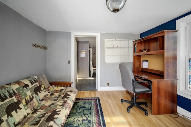 office area featuring baseboards and wood finished floors