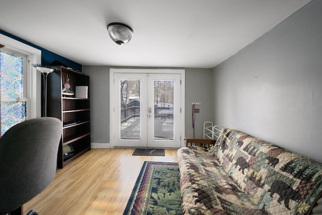 office space featuring french doors, light wood-type flooring, and baseboards