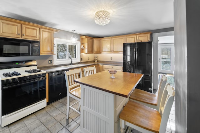 kitchen featuring black appliances, a kitchen bar, a chandelier, open shelves, and a sink