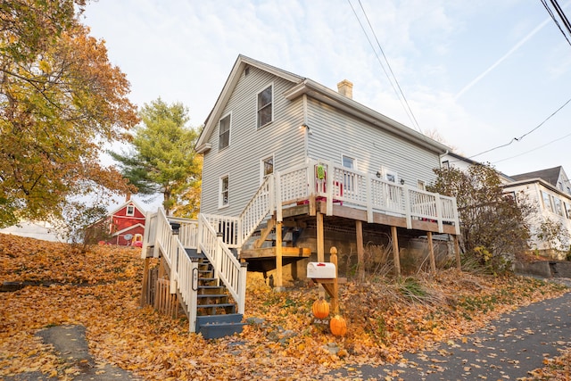 rear view of house featuring a deck