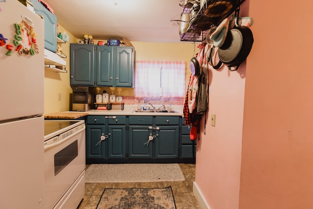 kitchen with white appliances, sink, and light tile patterned flooring