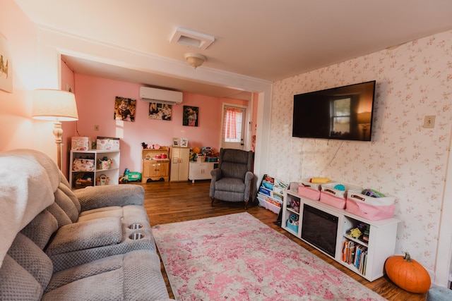 living room featuring dark wood-type flooring and a wall mounted AC