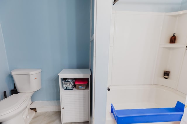 bathroom featuring toilet and washtub / shower combination